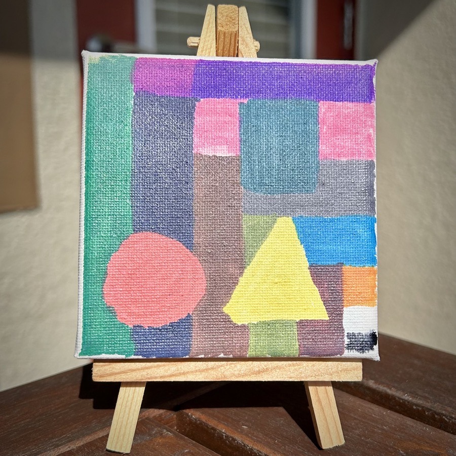 Mini painting of colored blocks, a circle, and a triangle